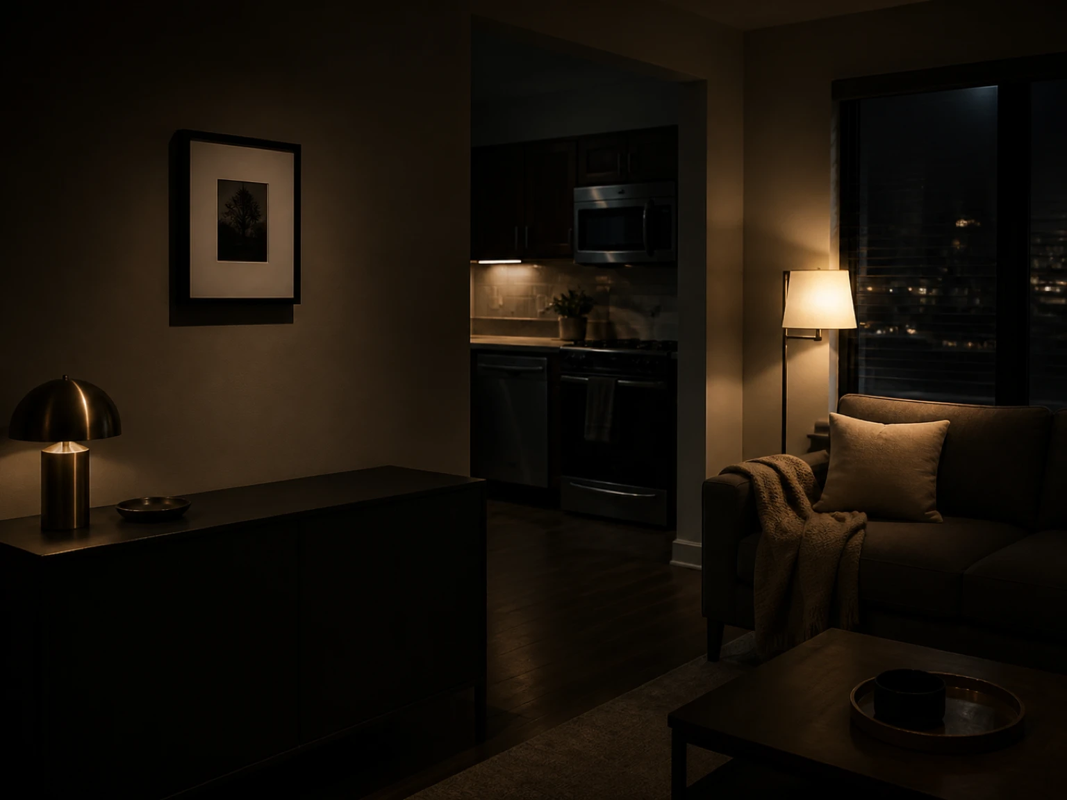 Small framed print mounted on a smooth painted rental wall above a dark console