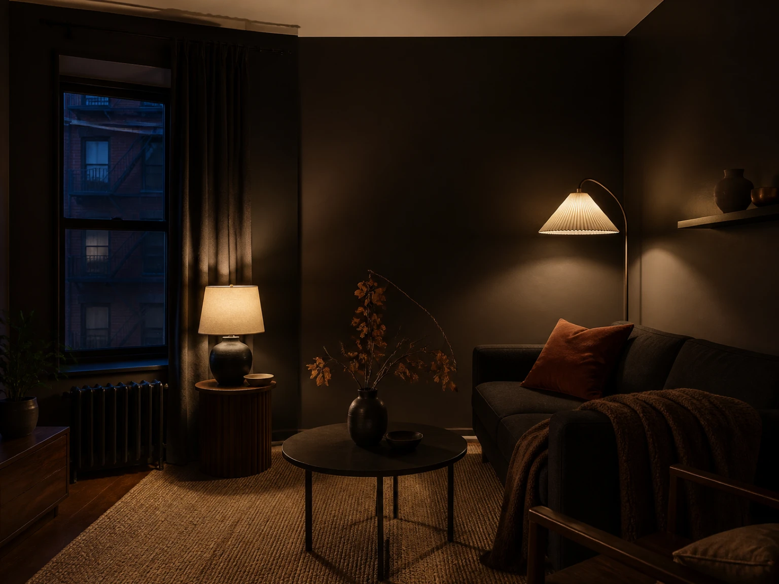 Dark cozy rental living room with warm lamps, rust textiles, and autumn branches